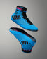A pair of high-top wrestling shoes in bright blue with black details and pink accents, shown from the side and sole views against a neutral gray background.