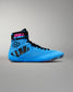A high-top wrestling shoe in bright blue with black details, featuring a black ankle strap with pink 'GODZILLA' text and a black claw-stripe graphic on the side.