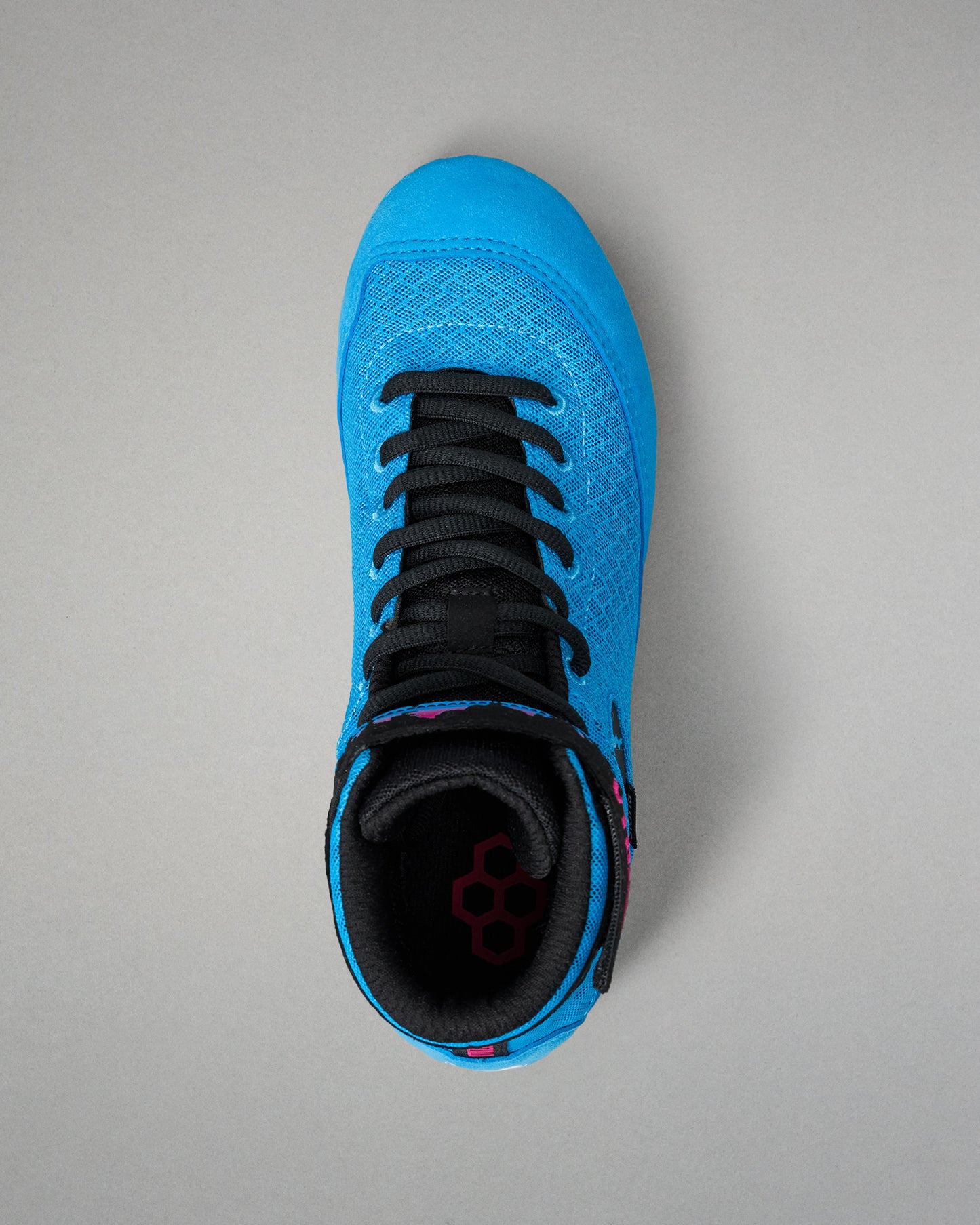 A bright blue high-top wrestling shoe with black laces and a black interior, shown from a top-down view on a neutral gray background.