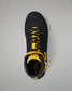 A black high-top wrestling shoe with bright yellow accents on the laces, collar, and heel, shown from a top-down view on a neutral gray background.