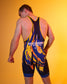 A man wearing a King Kong wrestling singlet, shown from behind against a solid yellow studio background. The singlet features a dark navy blue base with vibrant yellow and orange flame-like patterns and white text.
