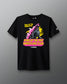 A black short-sleeve graphic t-shirt featuring a Godzilla design with pink spikes, yellow text reading 'King of the Mat Wrestling Club', and the Rudis brand name printed below the graphic, displayed against a neutral gray background.