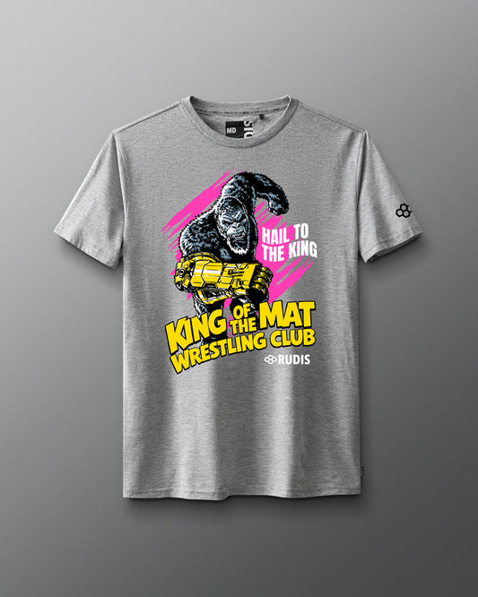 A heather gray short-sleeve t-shirt featuring a bold graphic print of a gorilla holding a gold trident, with the text 'HAIL TO THE KING', 'KING OF THE MAT WRESTLING CLUB', and '@RUDIS' on a gray gradient background.