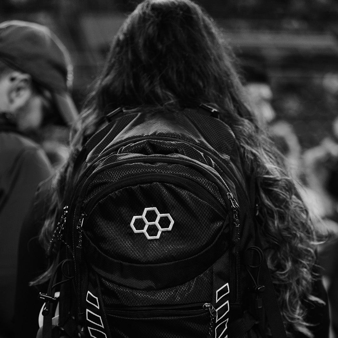 Black and white photo of a female wrestler wearing a RUDIS Genesis Gearpack IV, highlighting durable design, spacious storage, and performance-ready style for carrying wrestling gear.