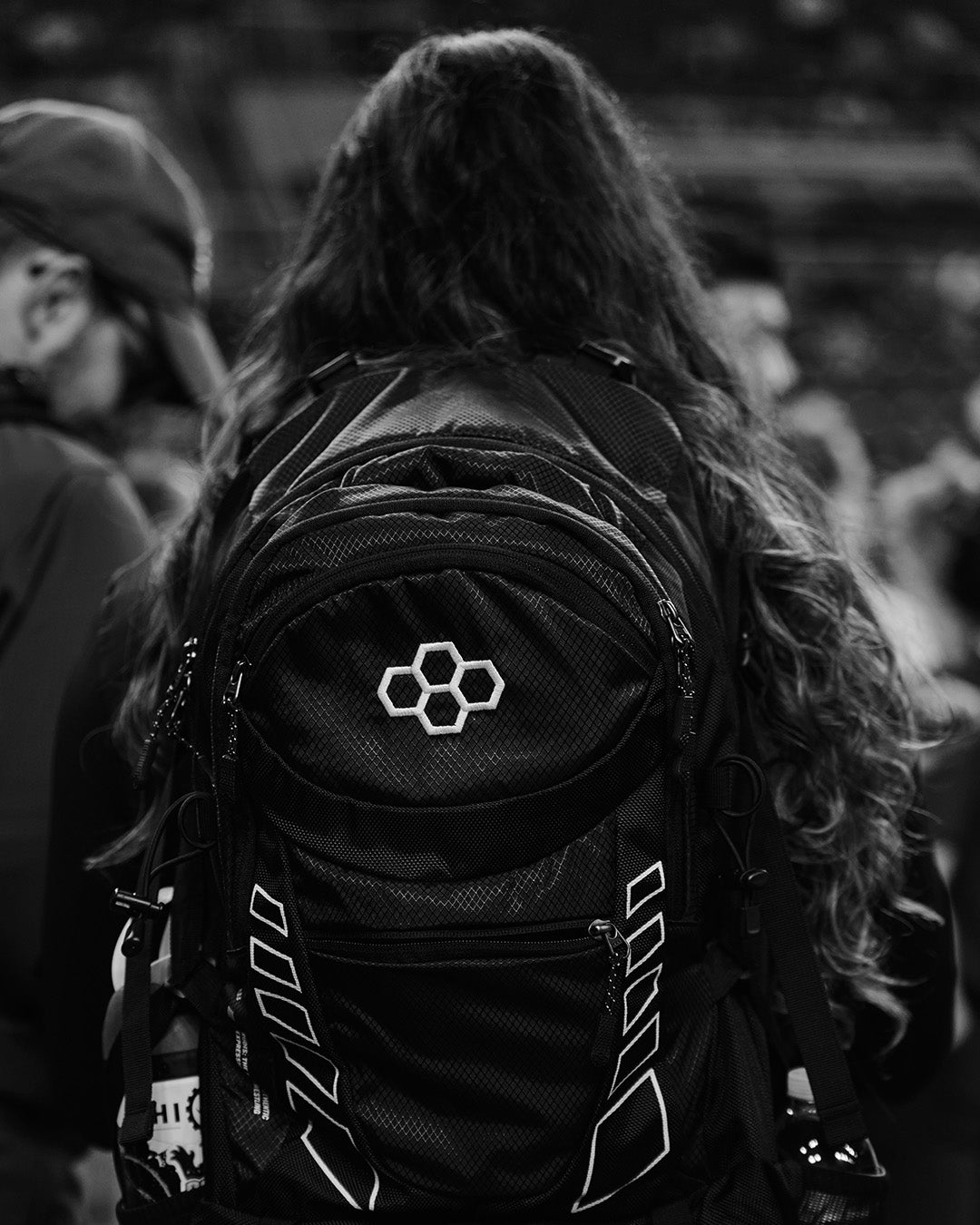 Black and white photo of a female wrestler wearing a RUDIS Genesis Gearpack IV, highlighting durable design, spacious storage, and performance-ready style for carrying wrestling gear.