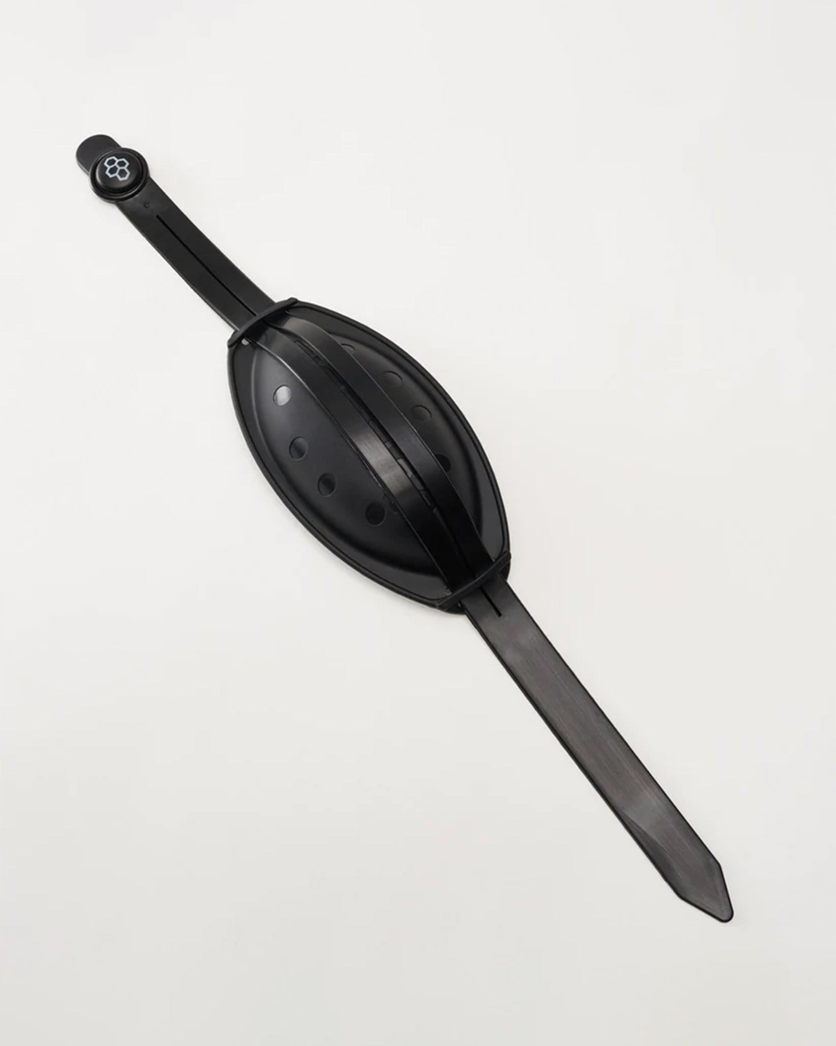 A sleek black chin cup designed for ease of use and functionality featuring an elongated body with a textured grip and a rounded top for easy handling