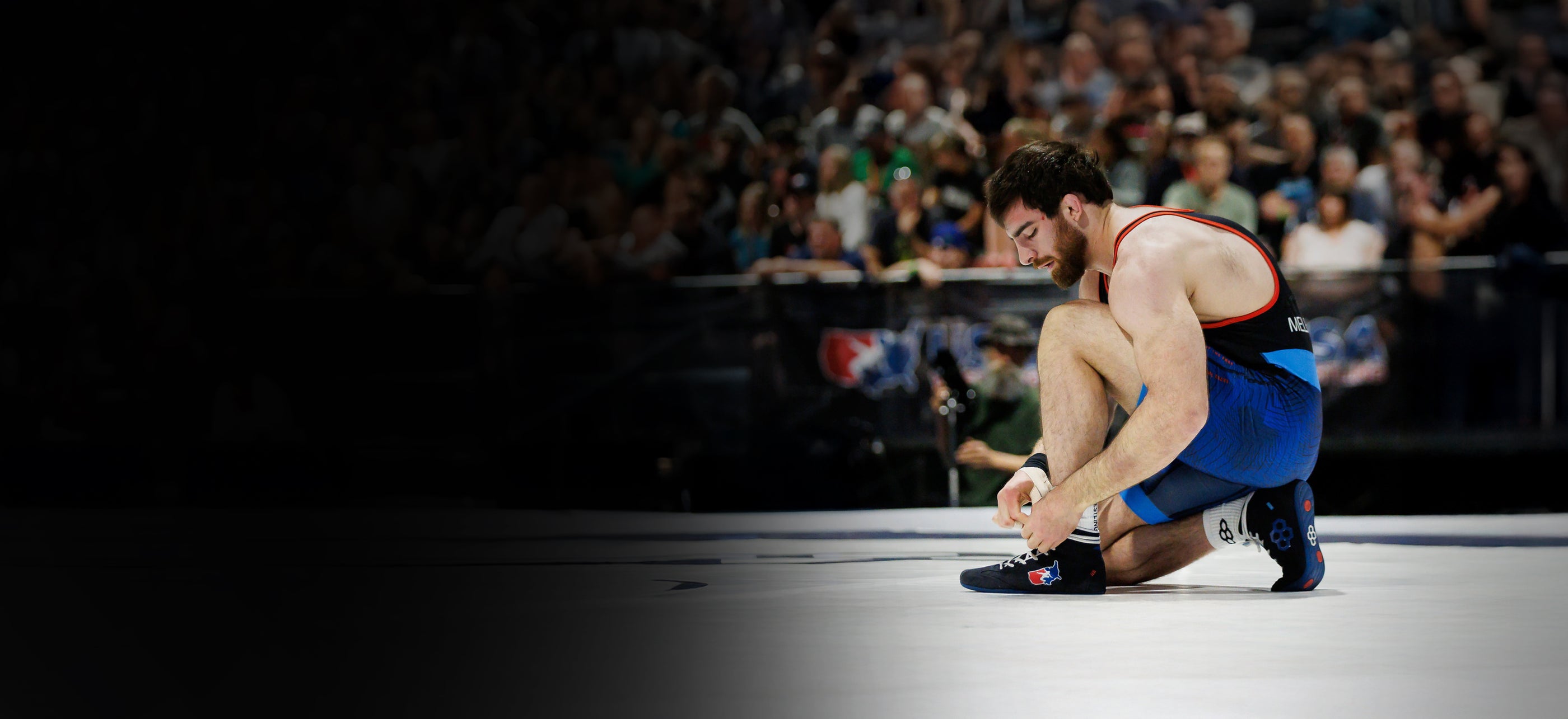 Banner image of Beka Melelashvili wearing the USA Wrestling RUDIS International wrestling shoes.