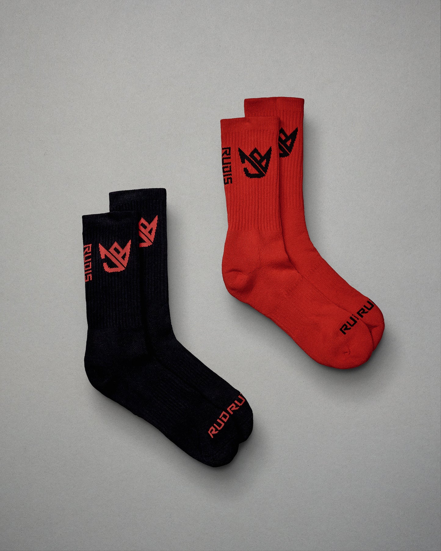 A pair of stylish athletic socks in black and red colors featuring a modern design and bold branding