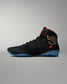 Black wrestling shoe with blue sole on a gray background