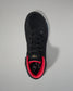 Black wrestling shoe with red lining on a gray background