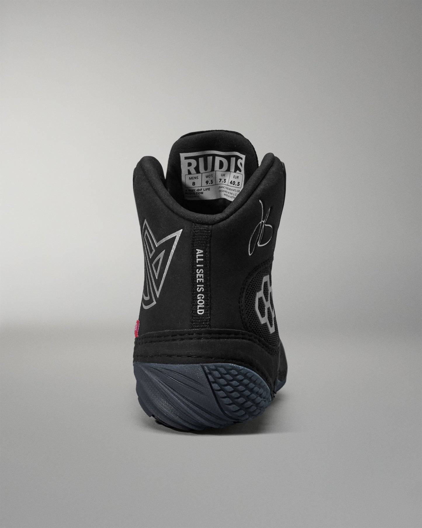 Black Jordan Burroughs wrestling shoes with text and branding on a gray background