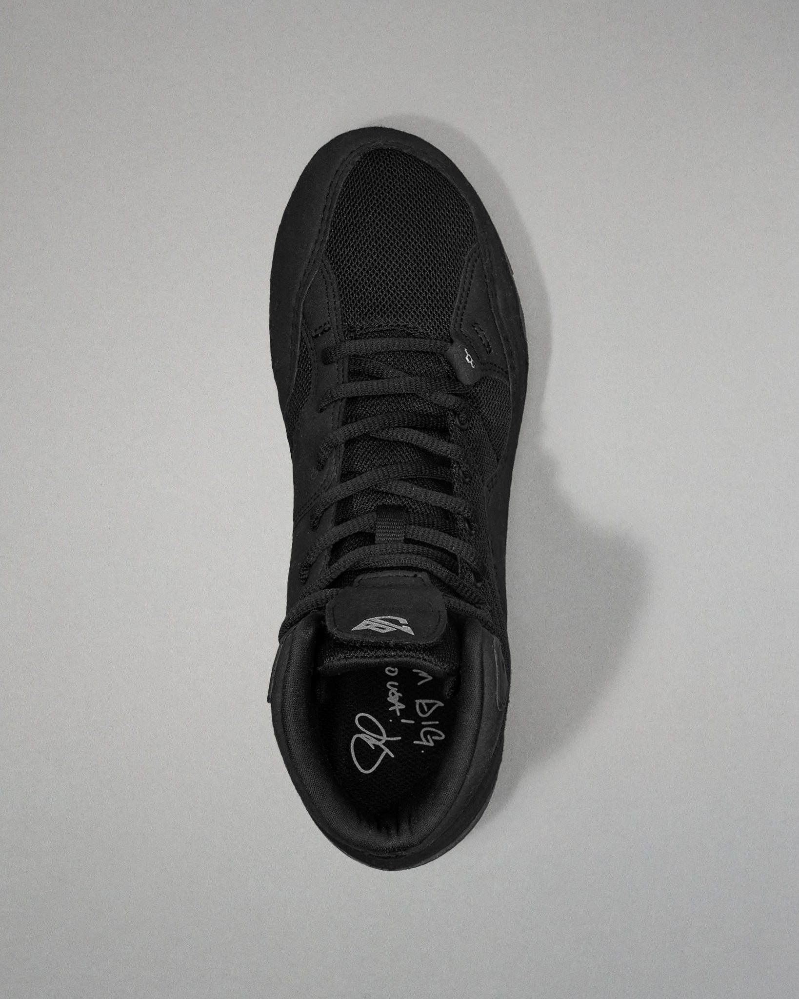 Black Jordan Burroughs wrestling shoes on a light gray background