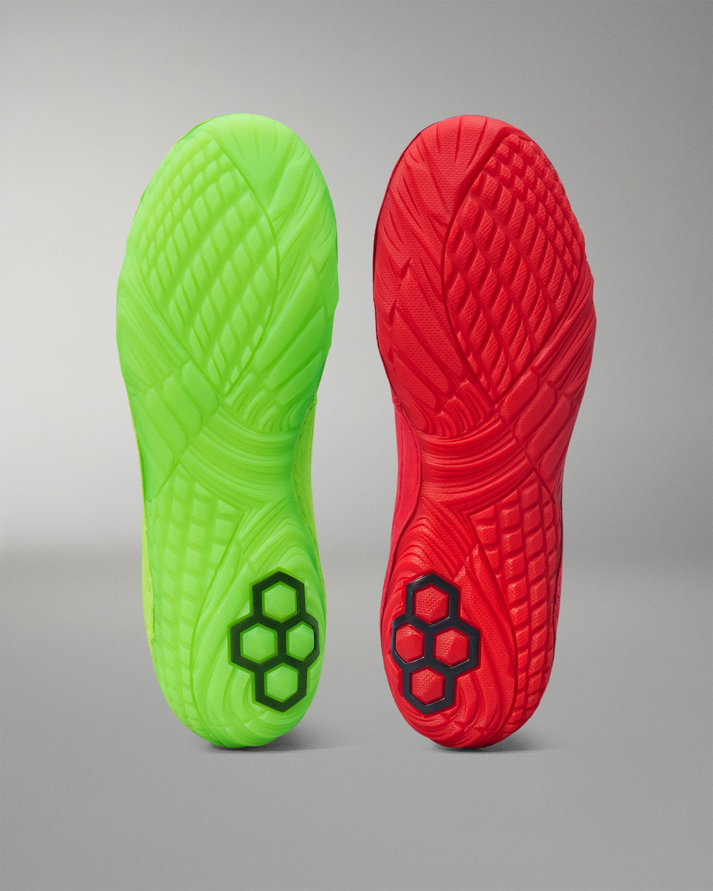 Green and red Wrestling shoes sole with textured pattern on a gray background