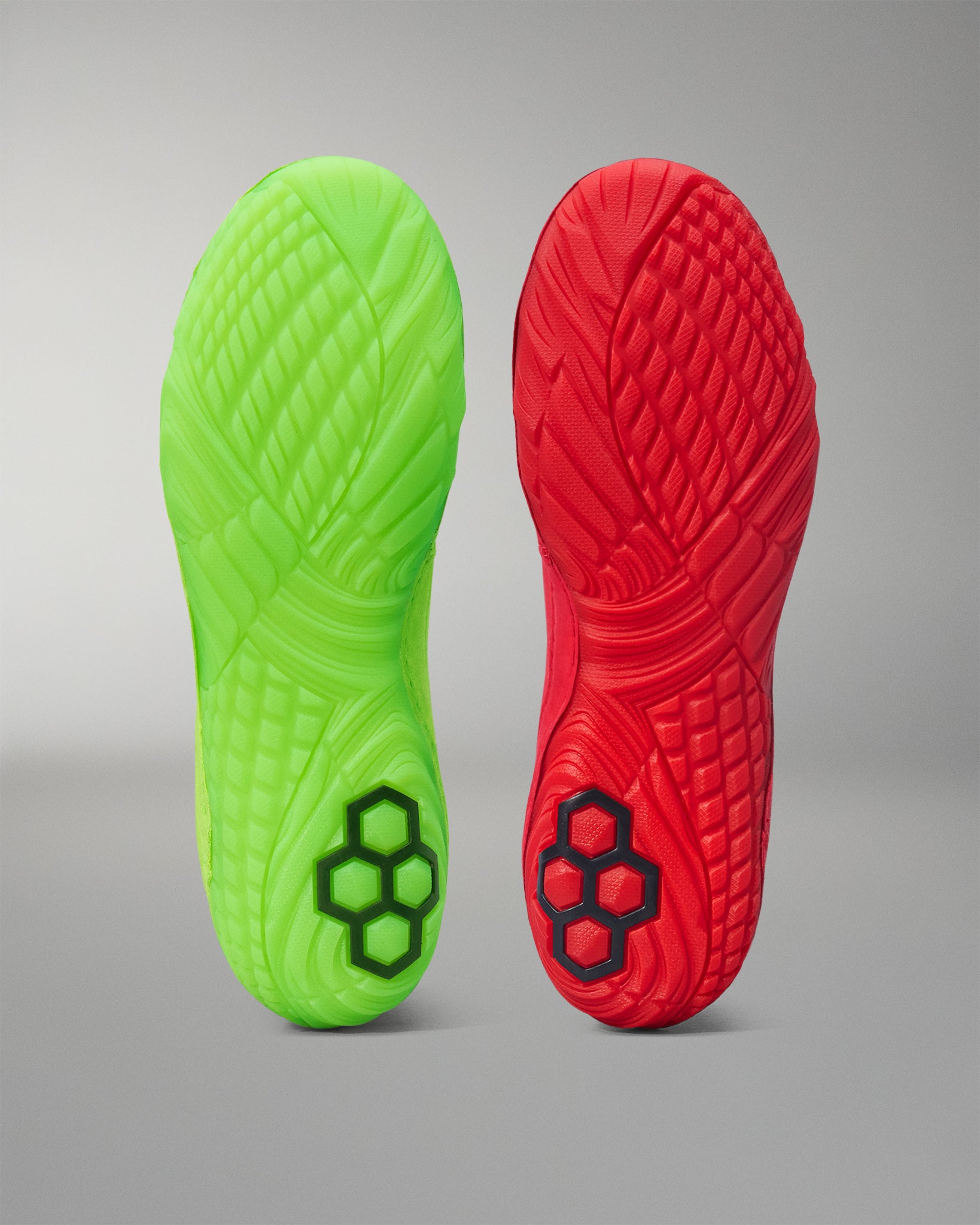 Green and red Wrestling shoes sole with textured pattern on a gray background