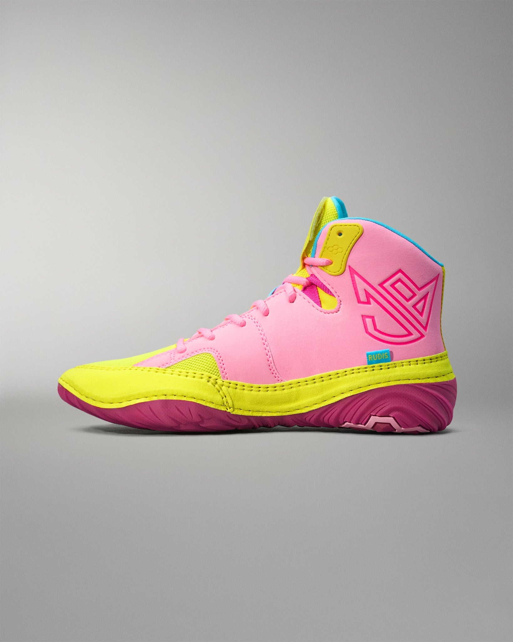Pink and yellow Wrestling shoe on a gray background