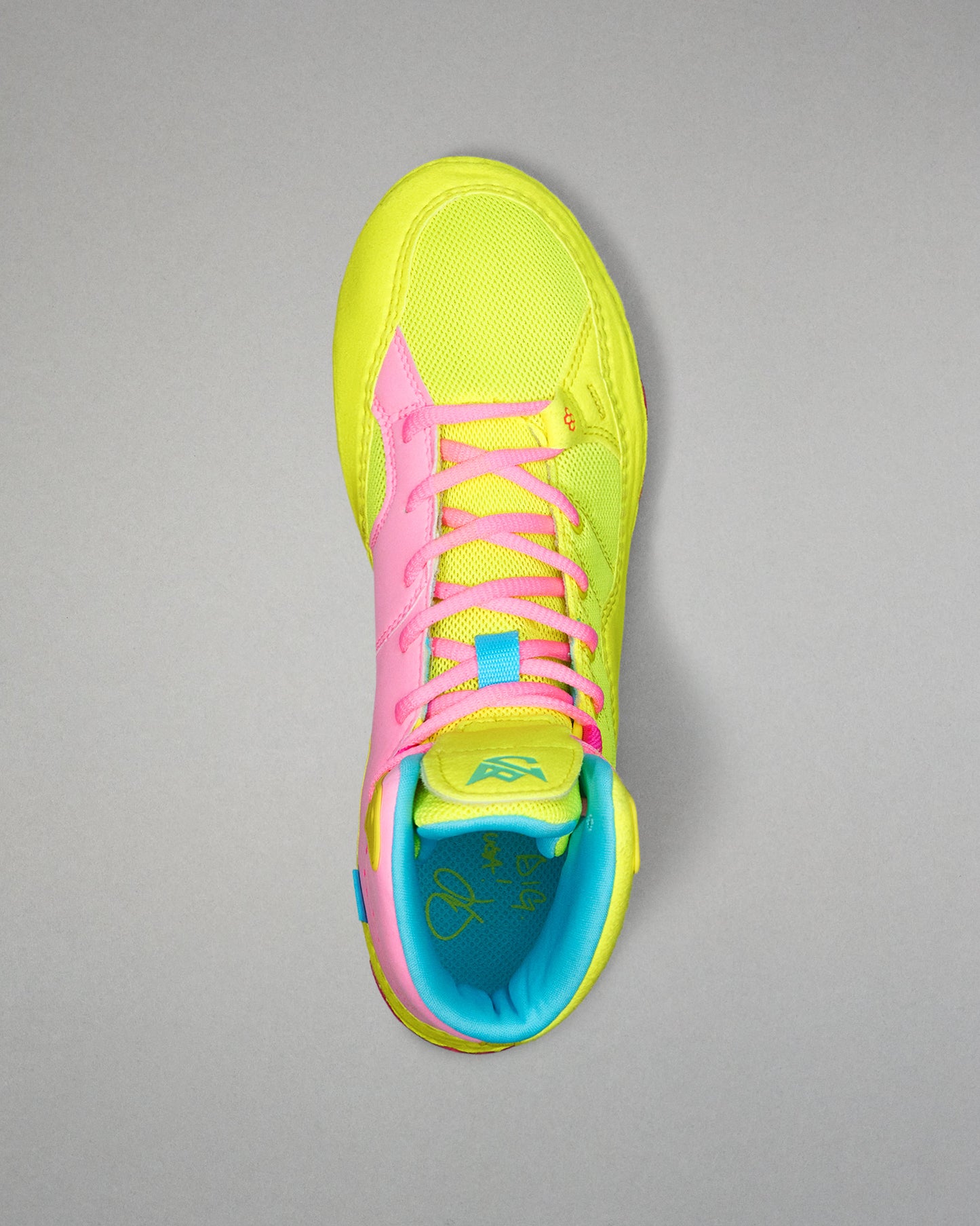 Neon yellow and pink Wrestling shoe with blue lining on a gray background
