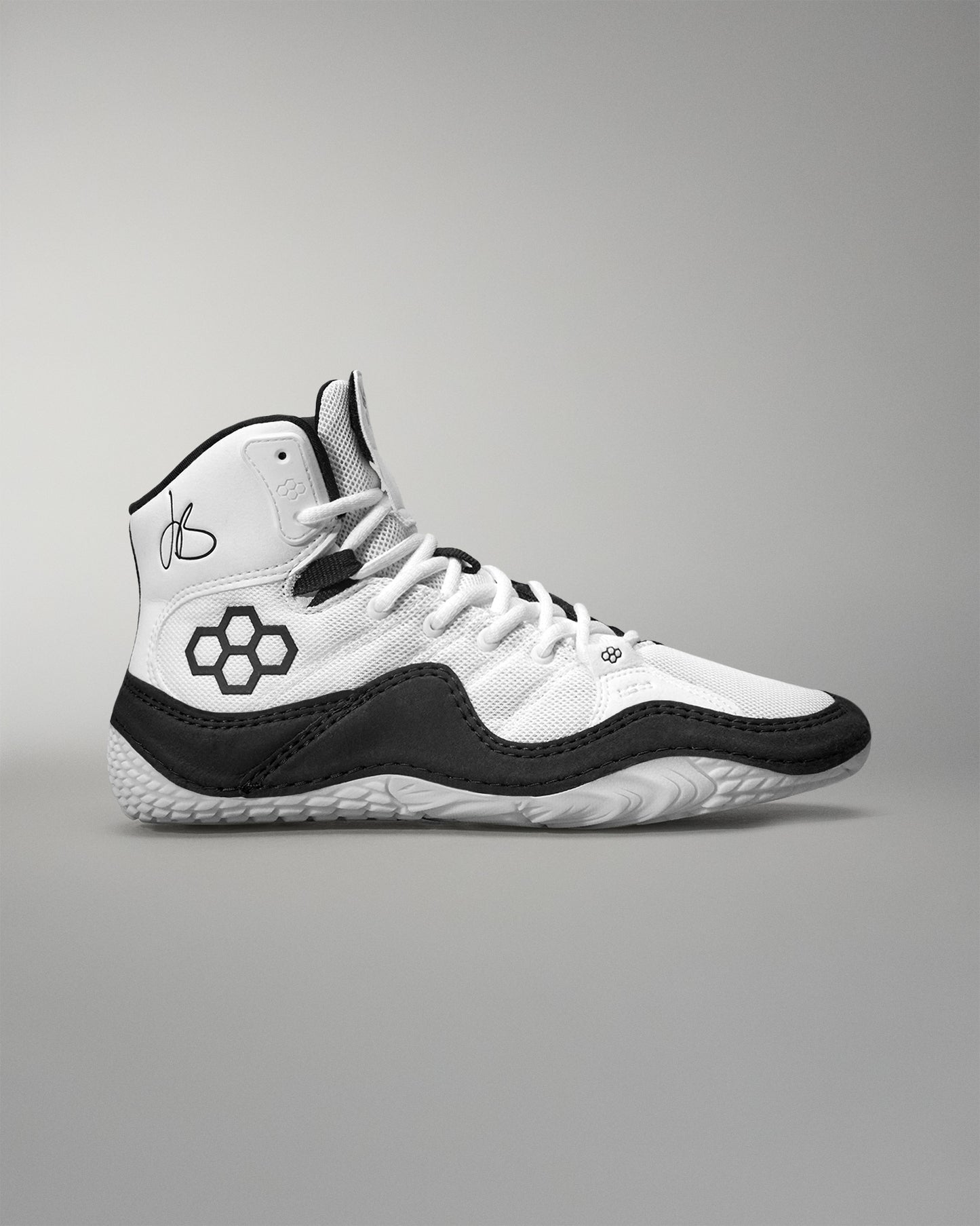 White and black Jordan Burroughs Wrestling shoes on a gray background