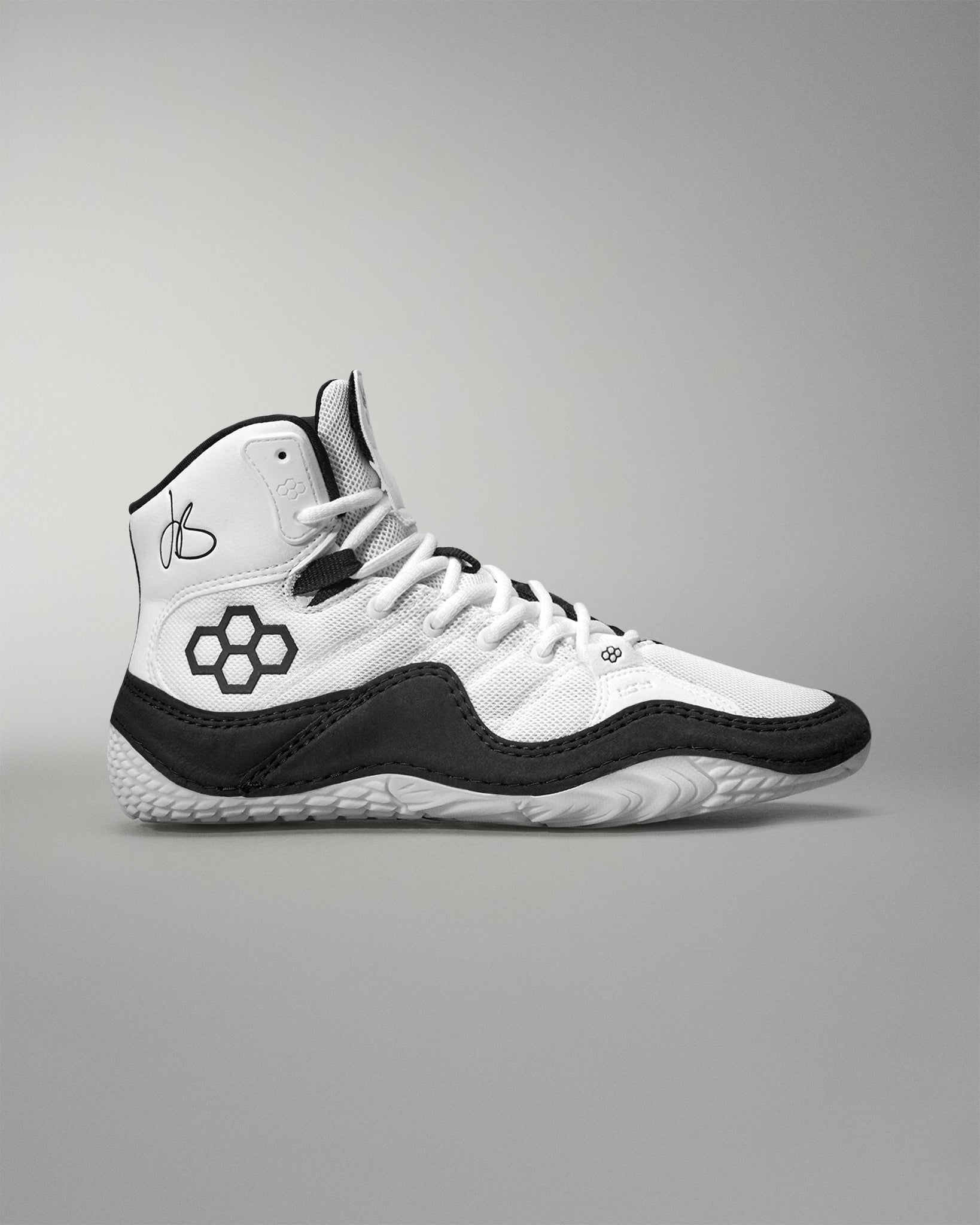 White and black Jordan Burroughs Wrestling shoes on a gray background