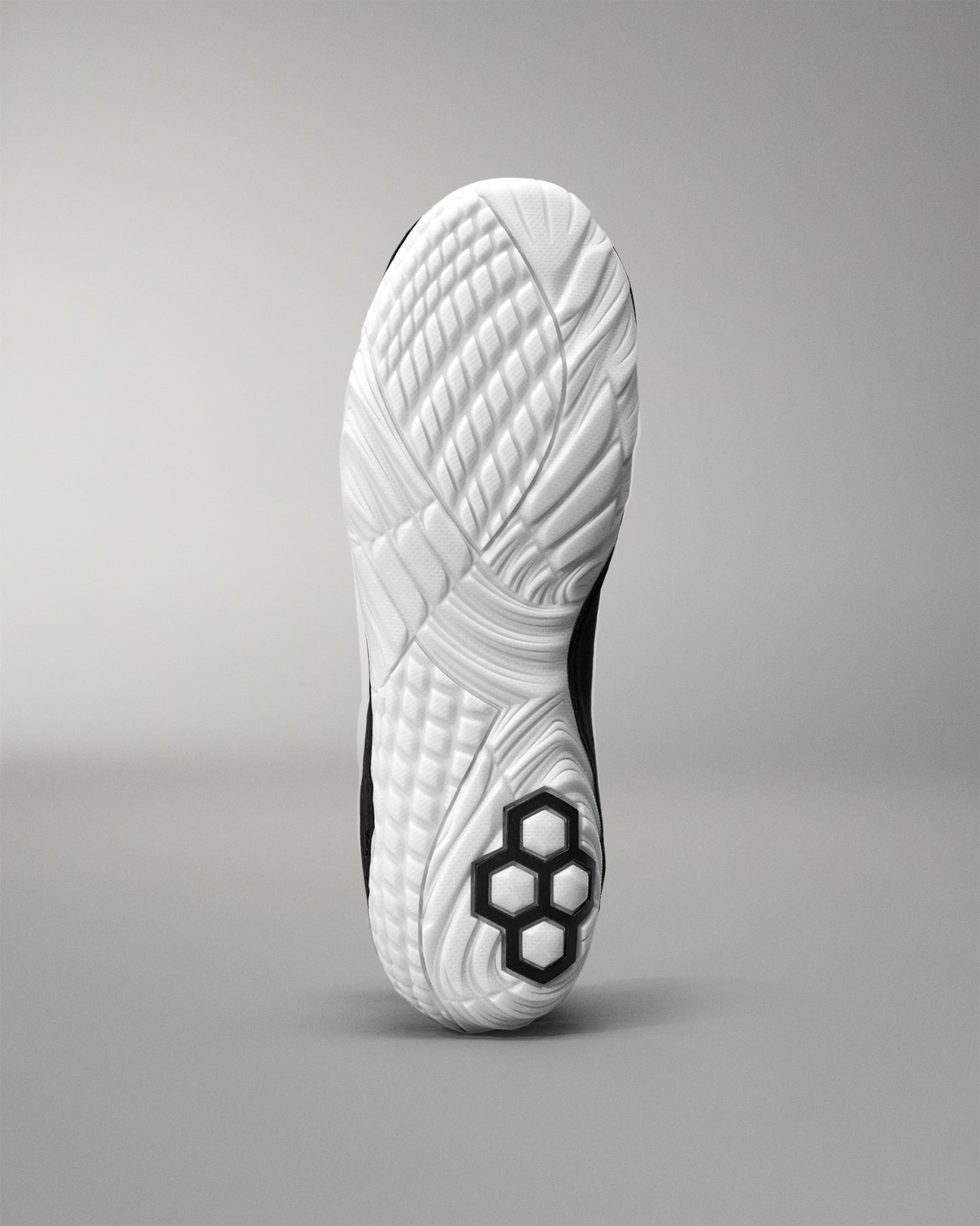 Close-up of a white Jordan Burroughs Wrestling shoes sole with a gray background