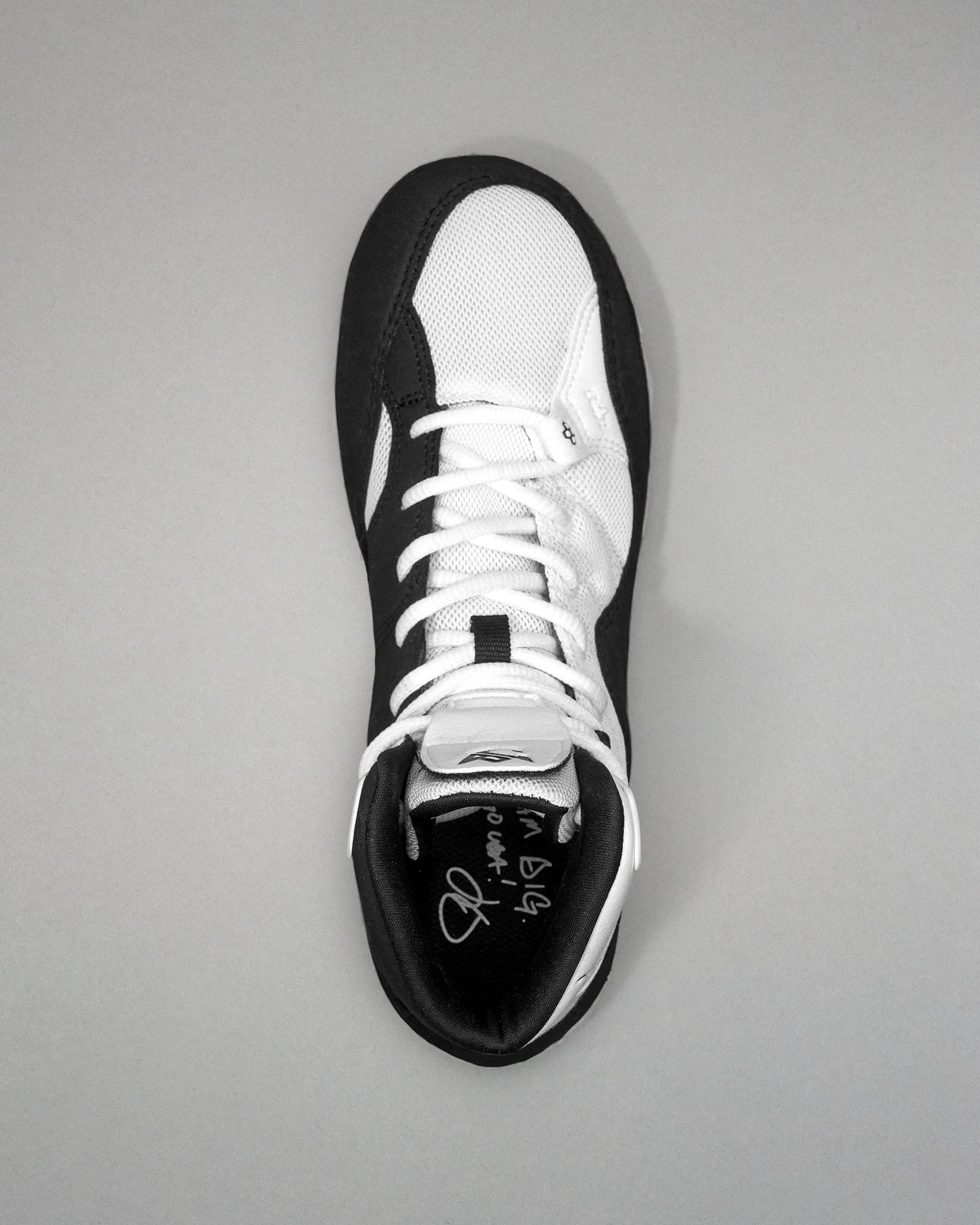 Black and white Jordan Burroughs Wrestling shoes on a gray background