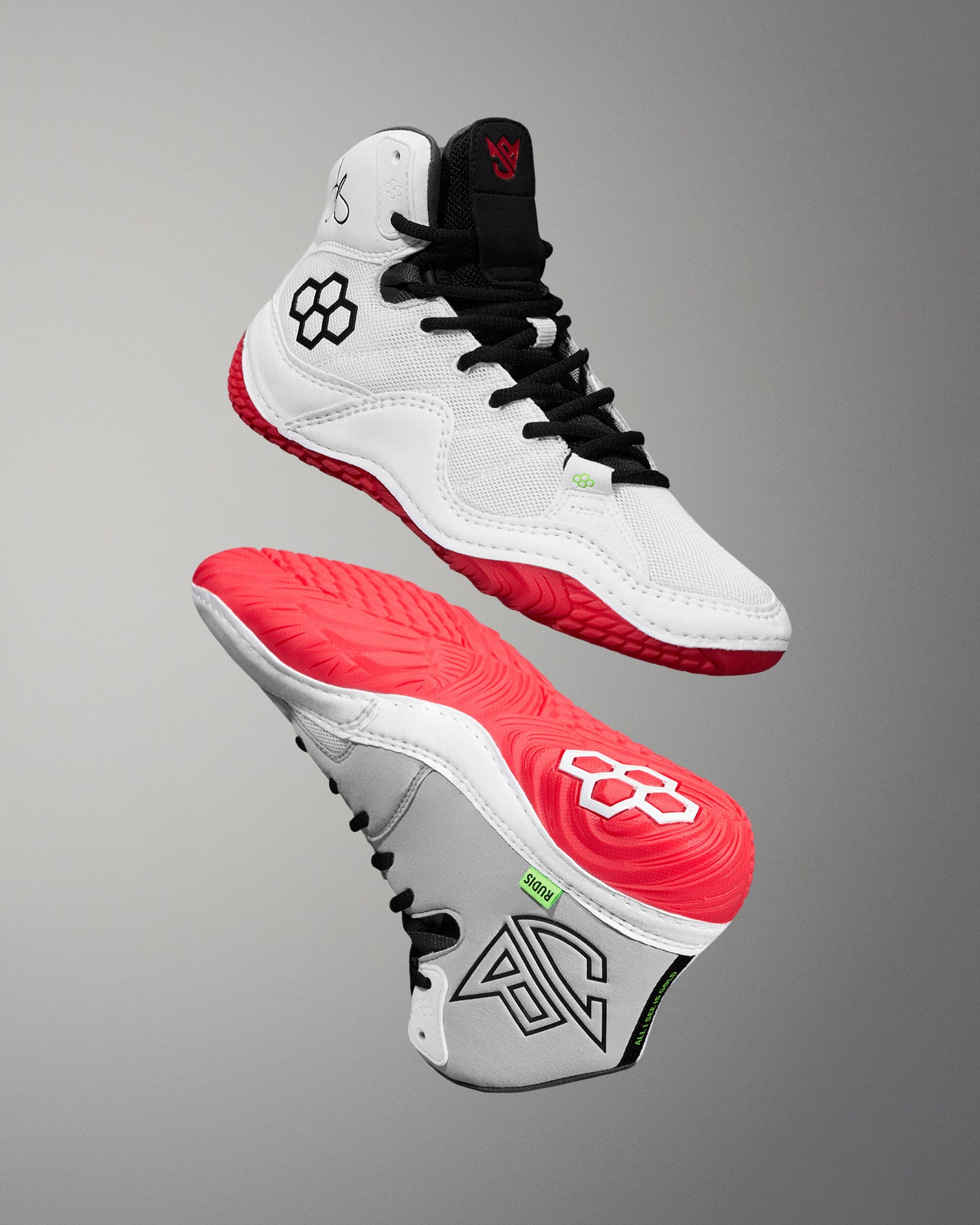 wrestling shoe with white, red, and black design on a gray background