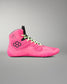 A high-top wrestling shoe in vibrant neon pink, featuring lime green laces, a black geometric logo on the side, and a black tongue label, set against a neutral gray background.