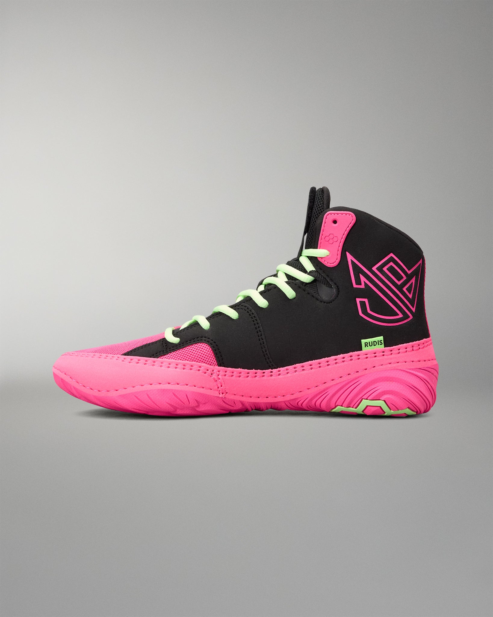 A high-top wrestling shoe in black and neon pink, featuring lime green laces and a small green 'RUDIS' logo on the side, set against a neutral gray background.
