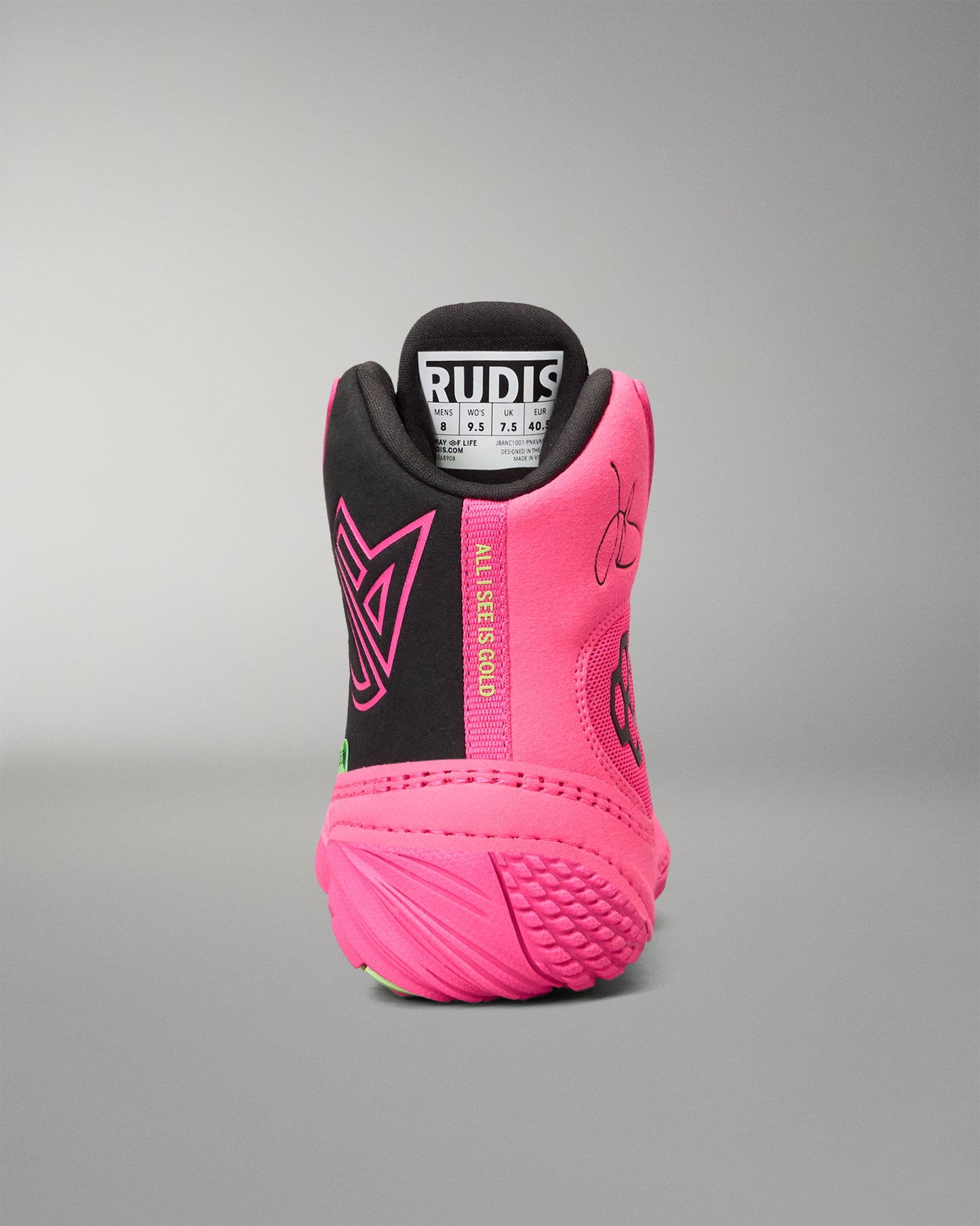 A high-top wrestling shoe shown from the back, featuring a vibrant neon pink and black colorway. The heel counter is black with a pink geometric logo, while the sides are bright pink with a vertical 'ALL I SEE IS GOLD' text detail.