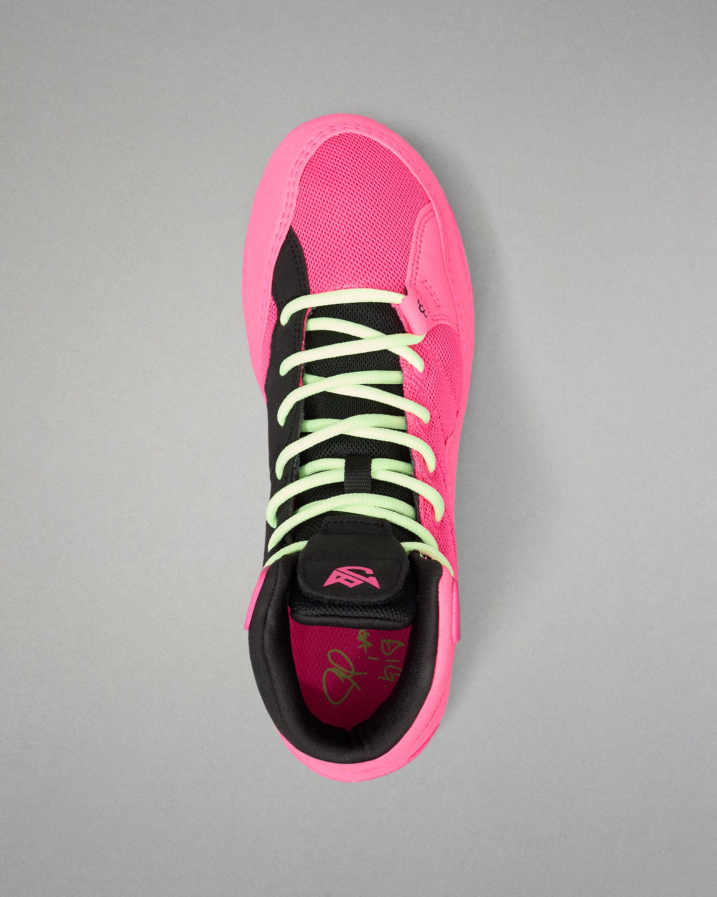 A high-top wrestling shoe shown from a top-down view, featuring a vibrant neon pink mesh upper with black overlays, lime green laces, and a matching pink and black collar.