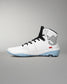 A high-top white wrestling shoes with black laces, a black geometric logo on the heel, and a light blue outsole, shown against a neutral gray background.