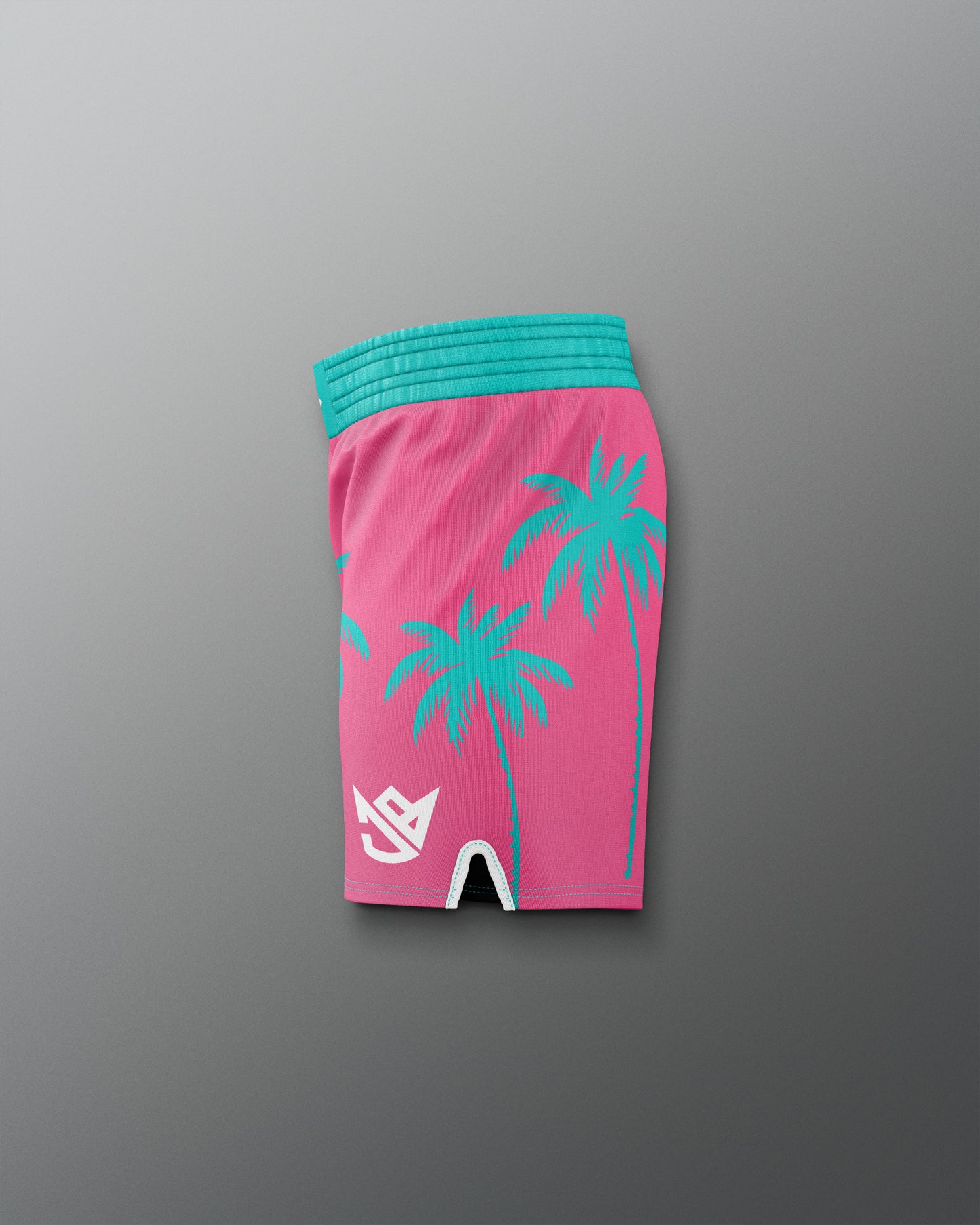 Pink shorts with teal palm tree design on a gray background