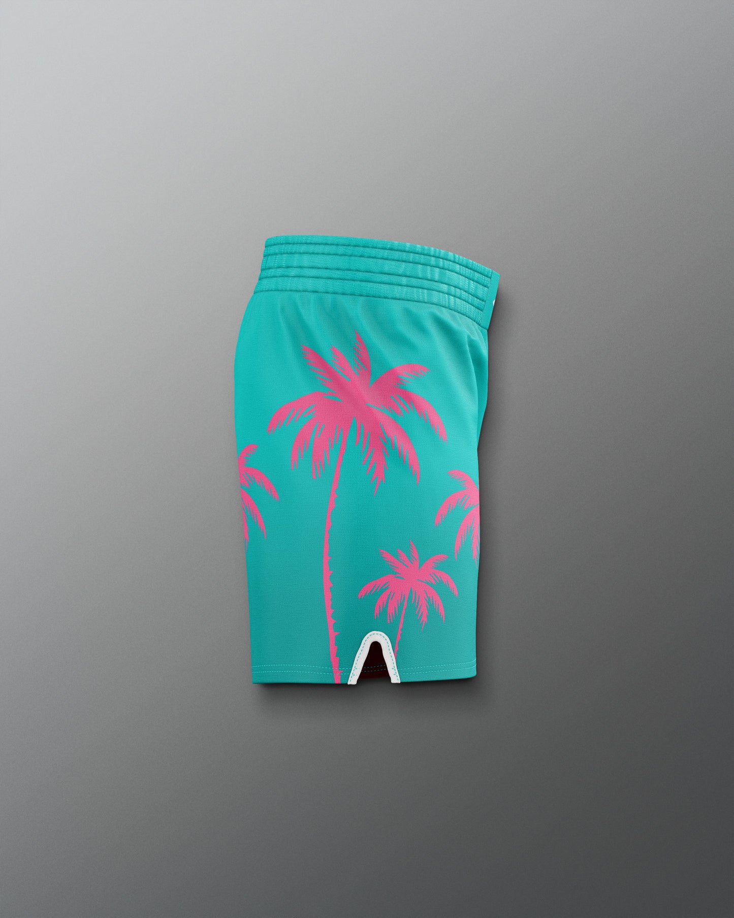 Turquoise shorts with pink palm tree design on a gray background