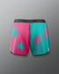Color-blocked shorts with palm tree design on a gray background