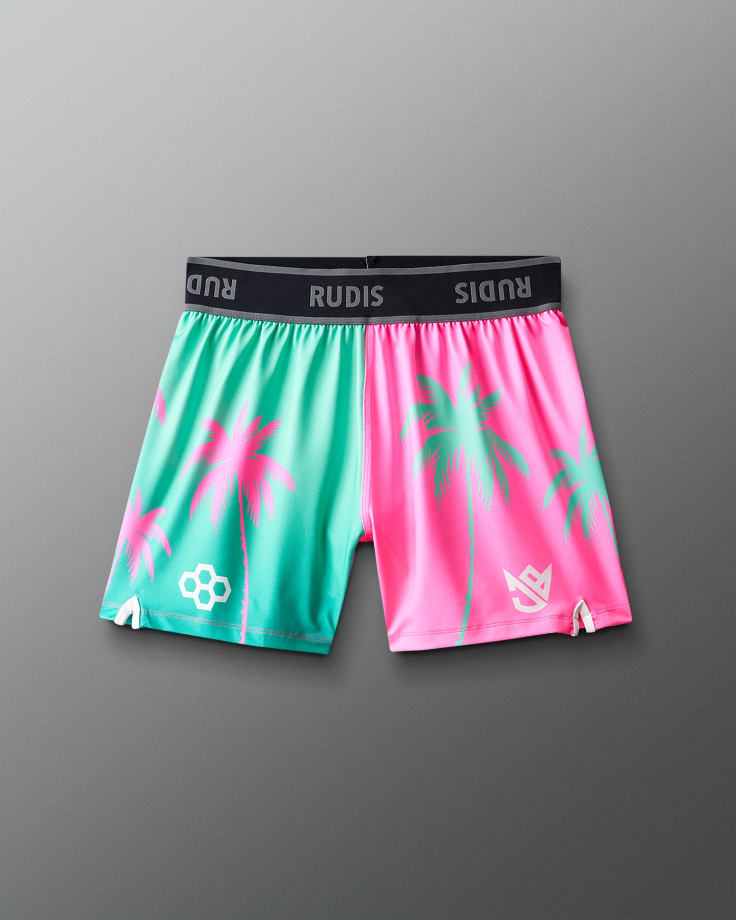 Colorful shorts with palm tree design on a gray background