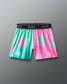 Colorful shorts with palm tree design on a gray background