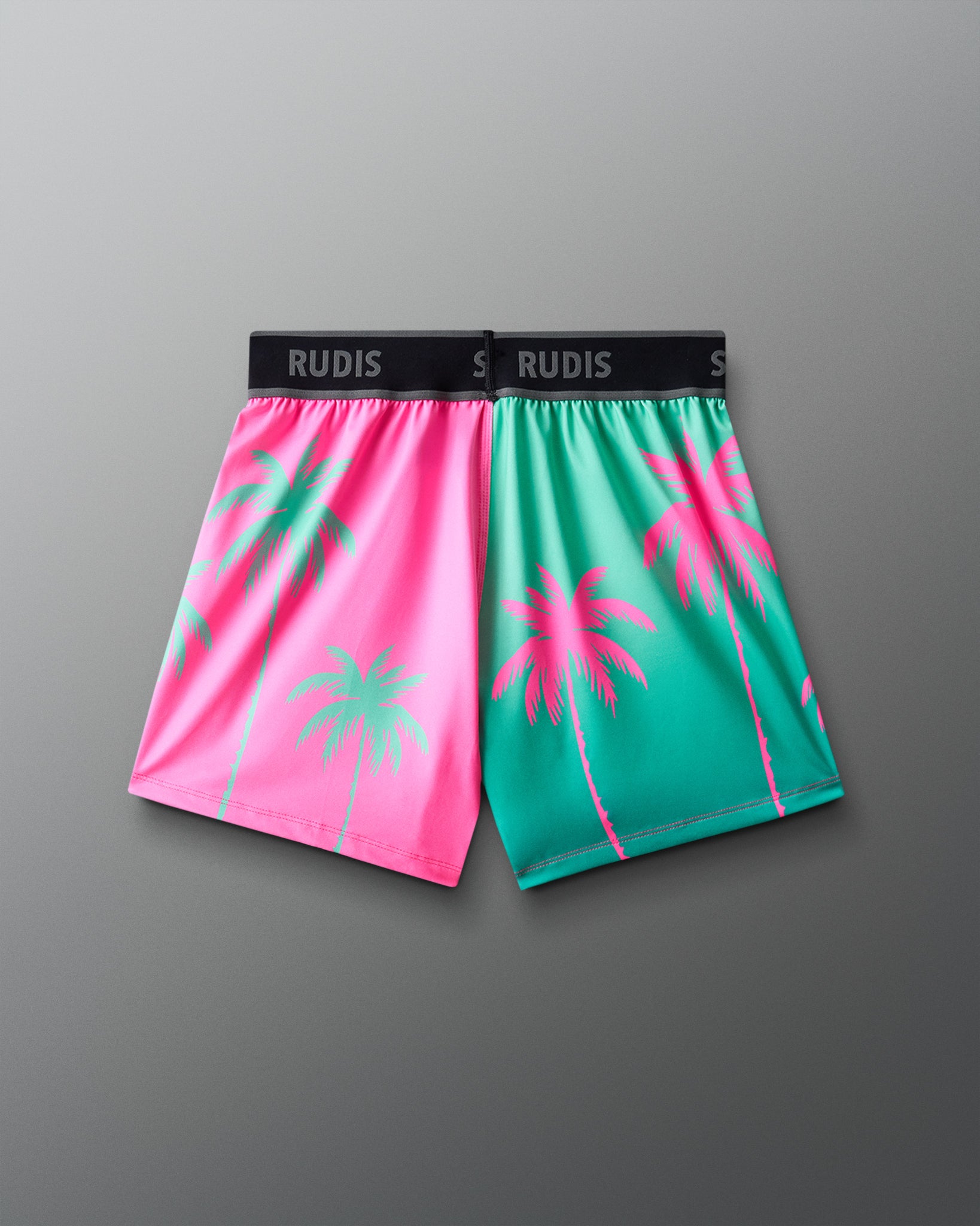 Color-blocked shorts with palm tree design on a gray background