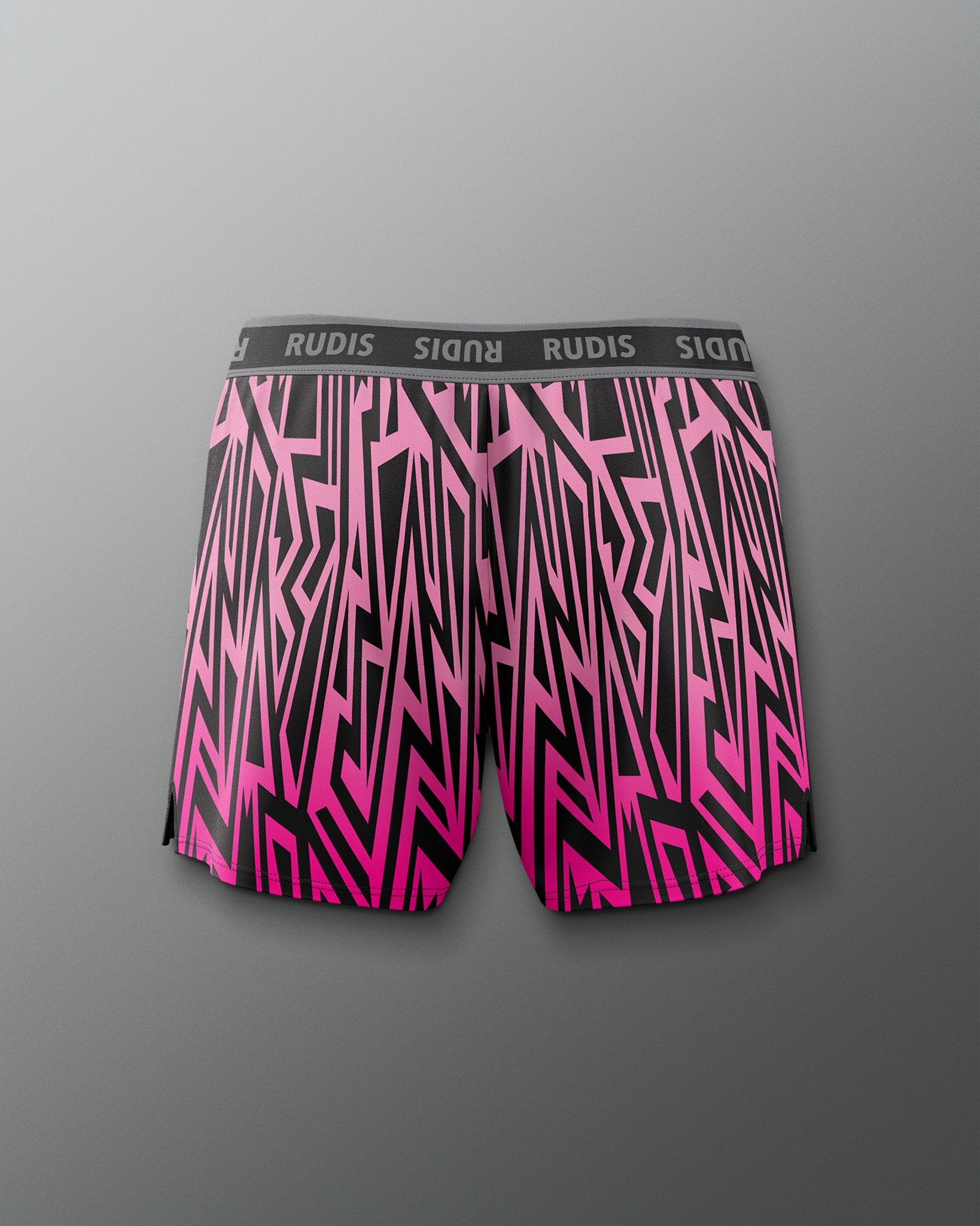 Pink and black patterned shorts with 'RUDIS' branding on a gray background