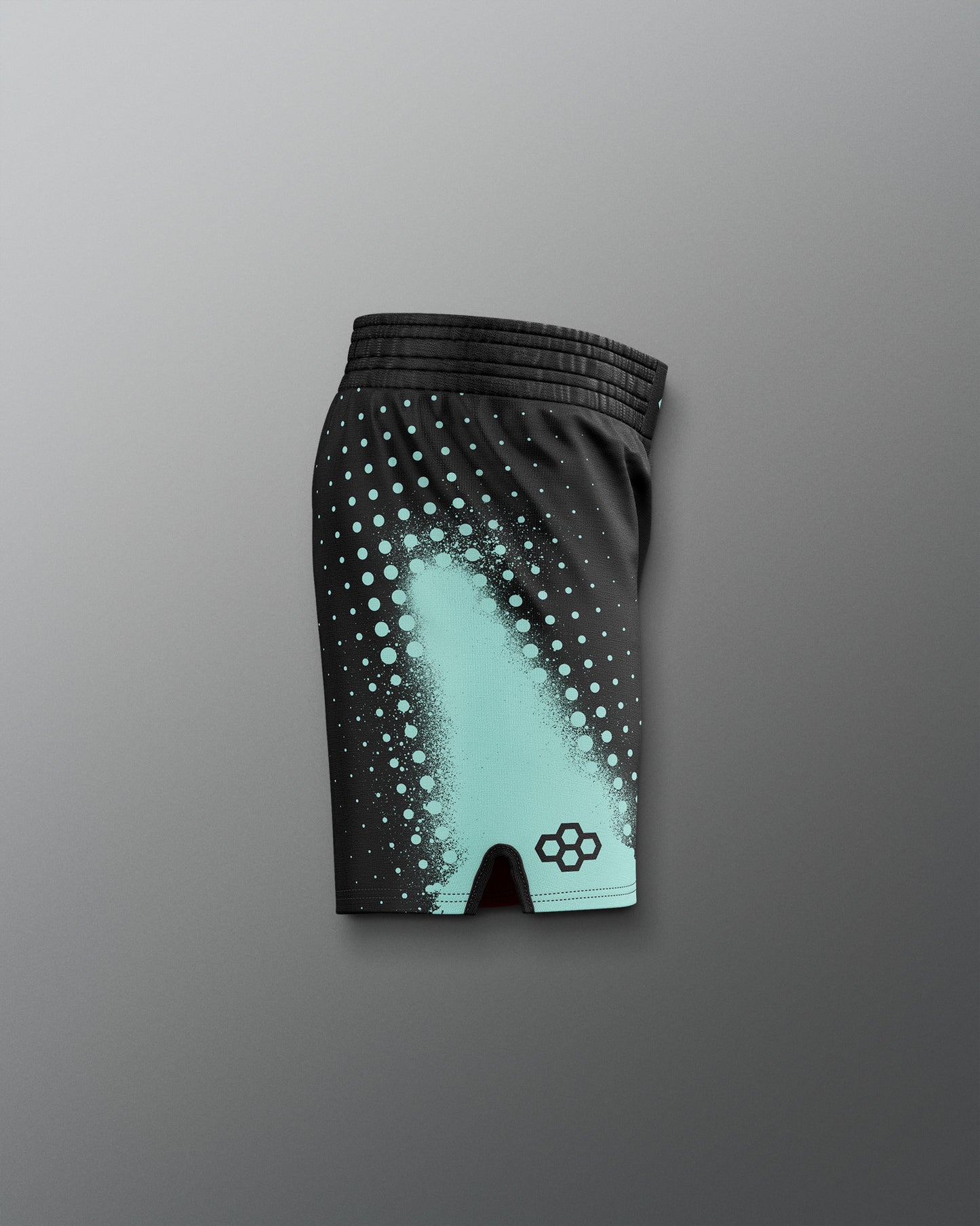 Black athletic shorts with teal pattern on a gray background