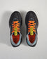 A pair of modern black running shoes with vibrant orange laces and a sleek design featuring a branded interior and multi-color accents