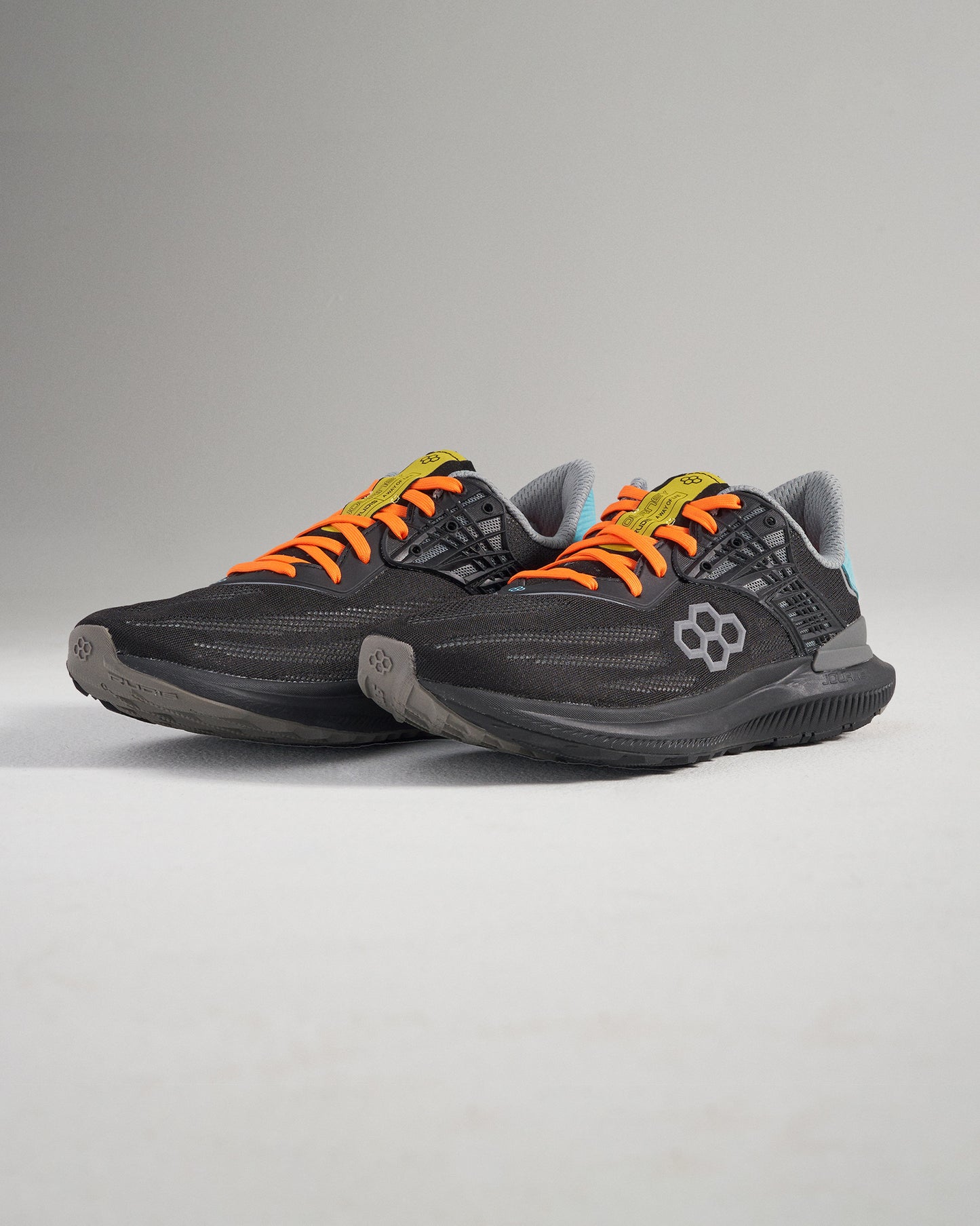 Sleek black athletic shoes with vibrant orange laces and modern design elements ideal for running or casual wear