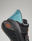A close-up view of a black and teal athletic shoe highlighting its design features and text that reads A WAY OF LIFE