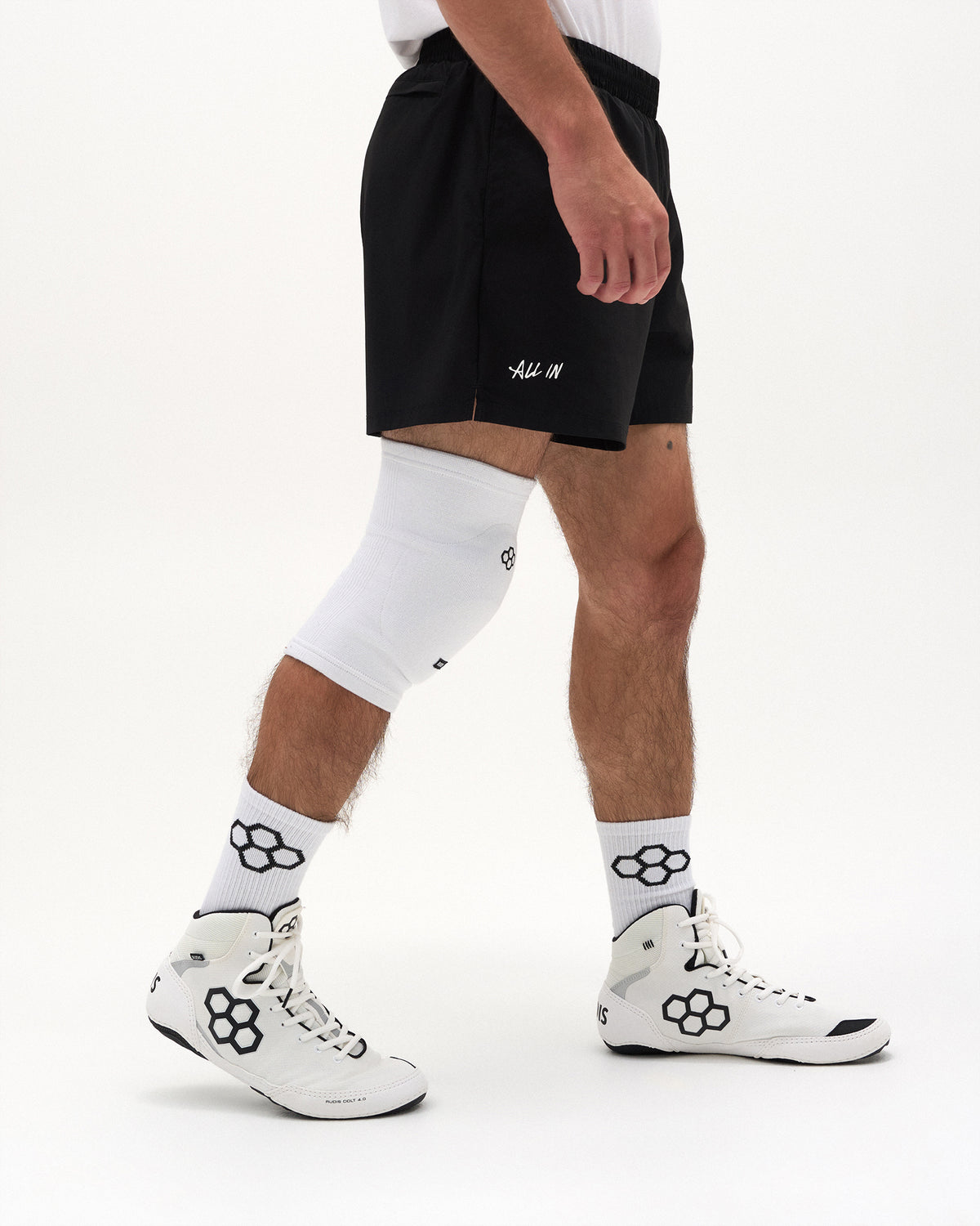 Side view of RUDIS Omni-Impact White Wrestling Knee Pad showing contoured fit around the knee
