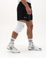 Side view of RUDIS Omni-Impact White Wrestling Knee Pad showing contoured fit around the knee