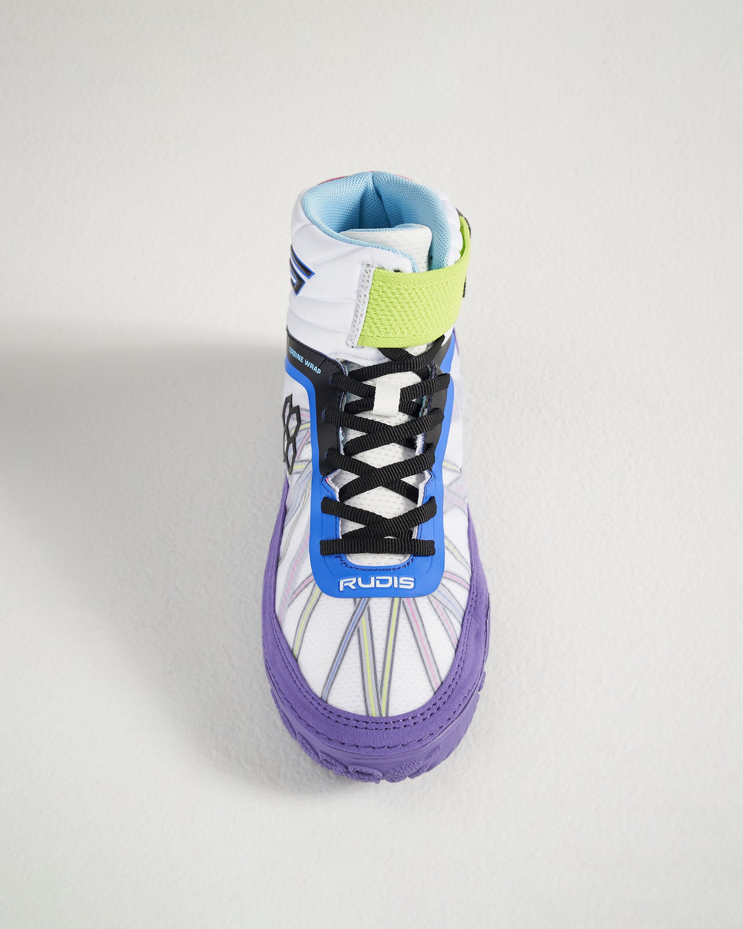A top view of a vibrant wrestling shoe featuring a unique design with purple accents black laces and a padded collar for support