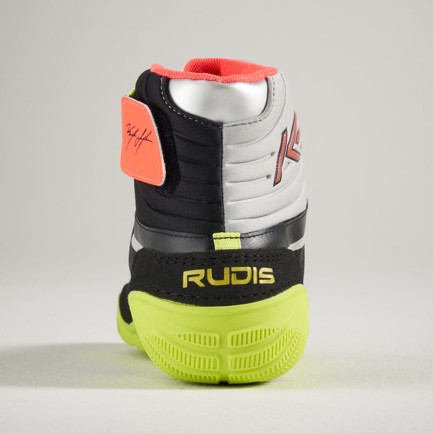 This image features a dynamic pair of wrestling shoes showcasing a black and gray color scheme with vibrant accents and a unique branding detail