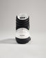This image displays the back view of a white and black wrestling shoe with detailed design elements and branding
