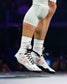 Athlete competing in white and gray RUDIS wrestling shoes with black laces and red performance detailing