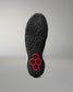 Bottom outsole view of RUDIS Infinity Edge wrestling shoe featuring aggressive traction pattern and red hex grip technology