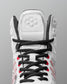 Close-up detail of RUDIS Infinity Edge wrestling shoe lacing system with black laces and red performance eyelets