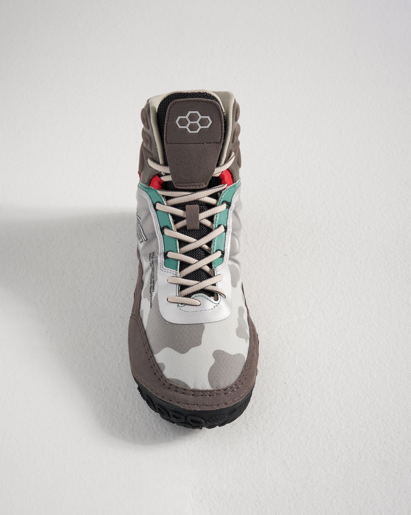 A stylish gray and white camouflage boot with colorful accents and sturdy construction highlighting a blend of modern design and functional features